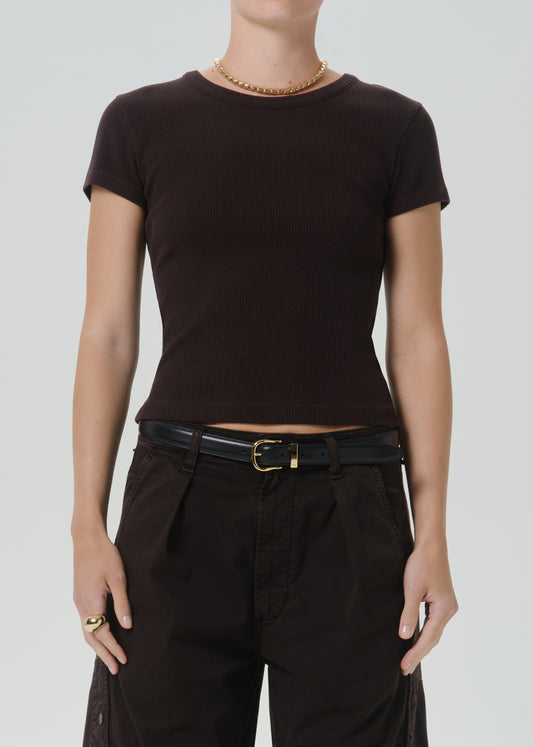 A model wearing a dark brown short-sleeve crewneck t-shirt, paired with black pants and a black belt, against a grey background.