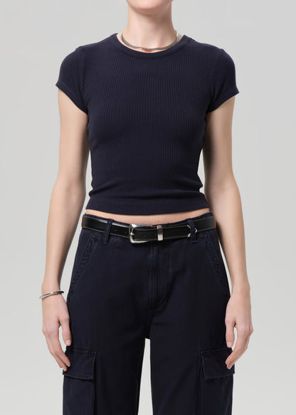 Person wearing a navy ribbed tee and navy cargo pants on a light gray background