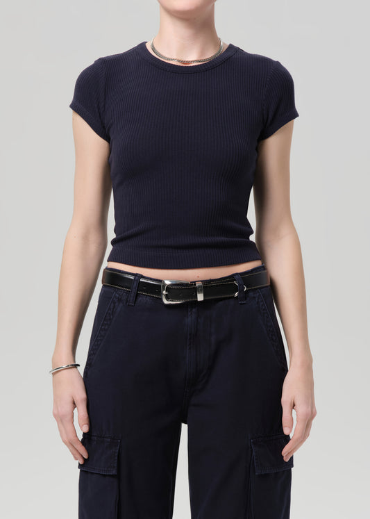 Person wearing a navy ribbed tee and navy cargo pants on a light gray background