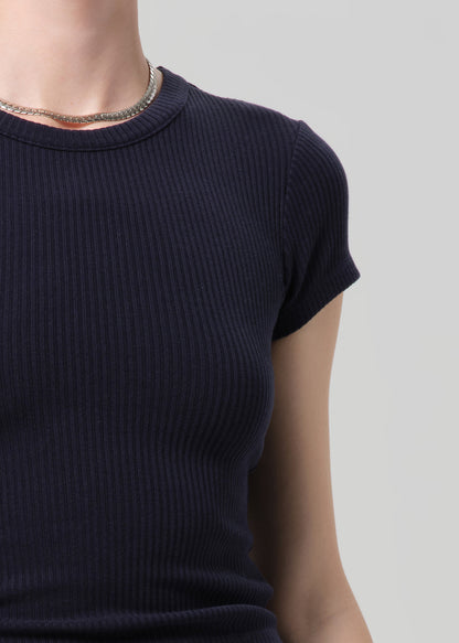 Person wearing a navy ribbed tee and navy cargo pants on a light gray background