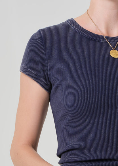 Navy ribbed knit top worn by a person on a light gray background
