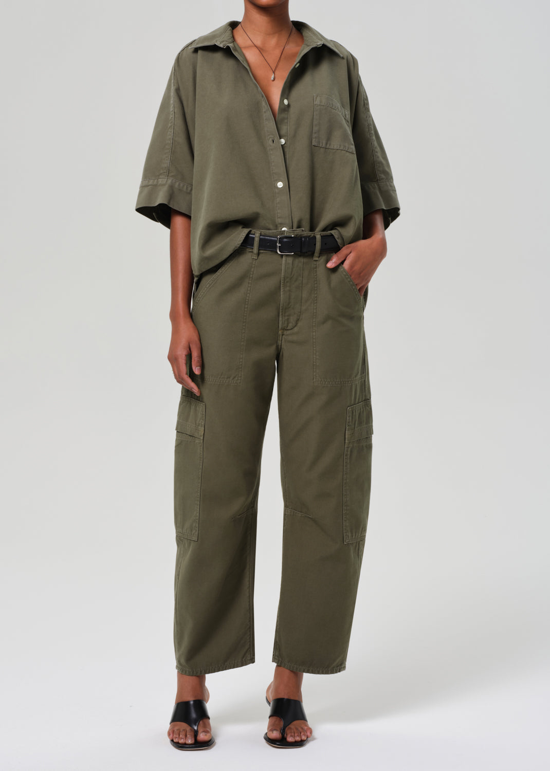 Person wearing a green outfit on a white background