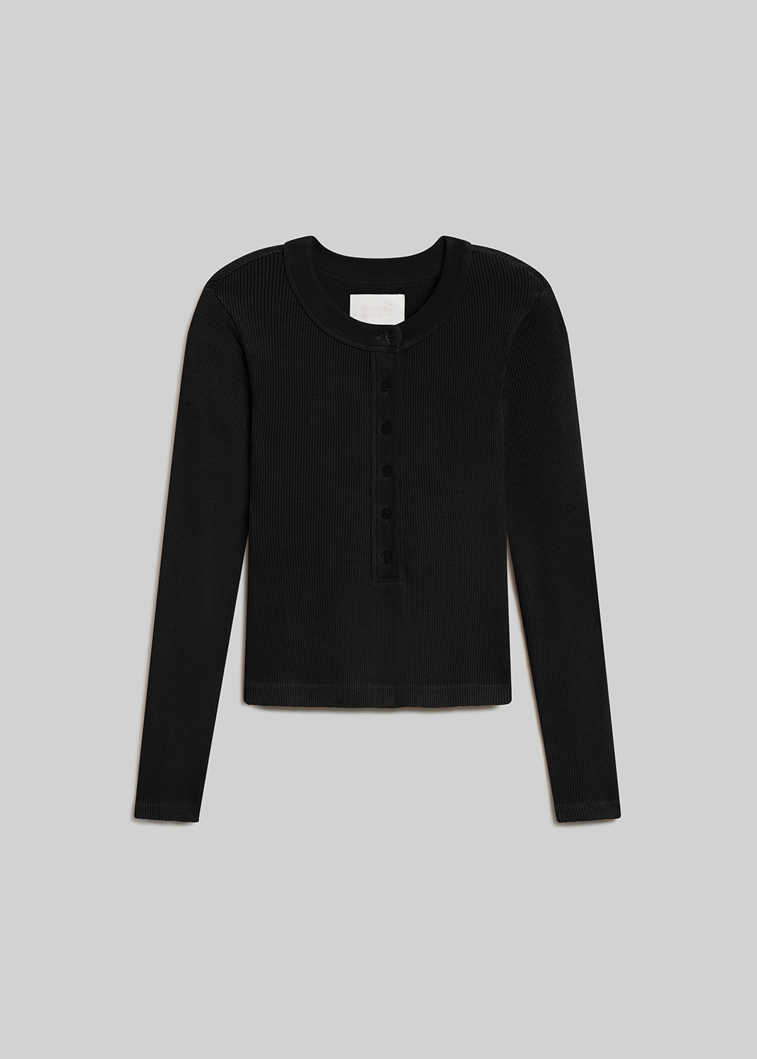 Black ribbed long sleeve henley top with button placket on grey background