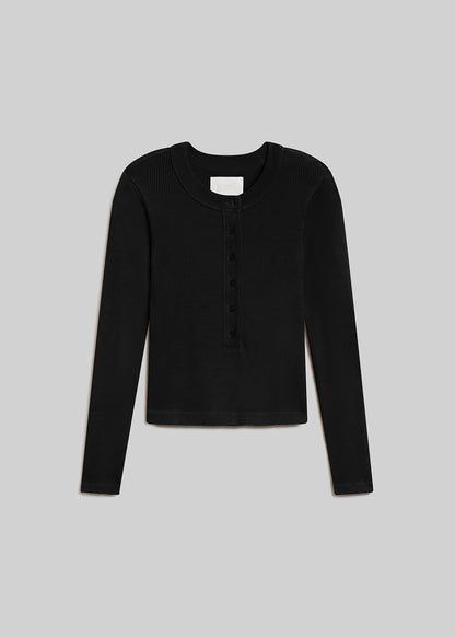 Black ribbed long sleeve henley top with button placket on grey background