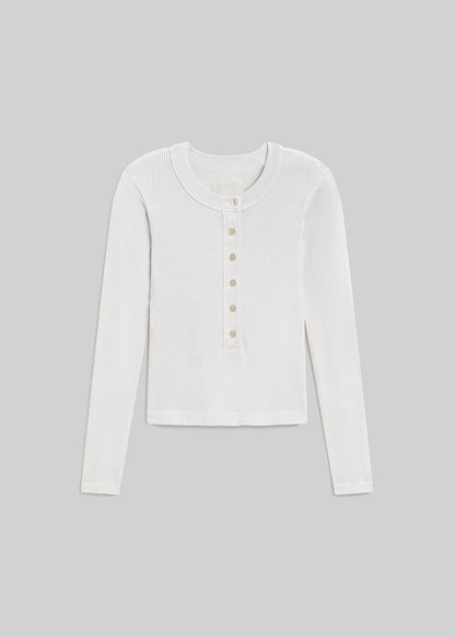 White ribbed long sleeve henley top with button placket on grey background