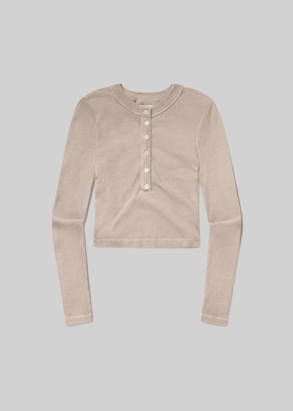 Beige long-sleeve ribbed Henley top with a round neckline, six-button front placket, fitted silhouette, and straight hem, front flat lay view on a grey background.