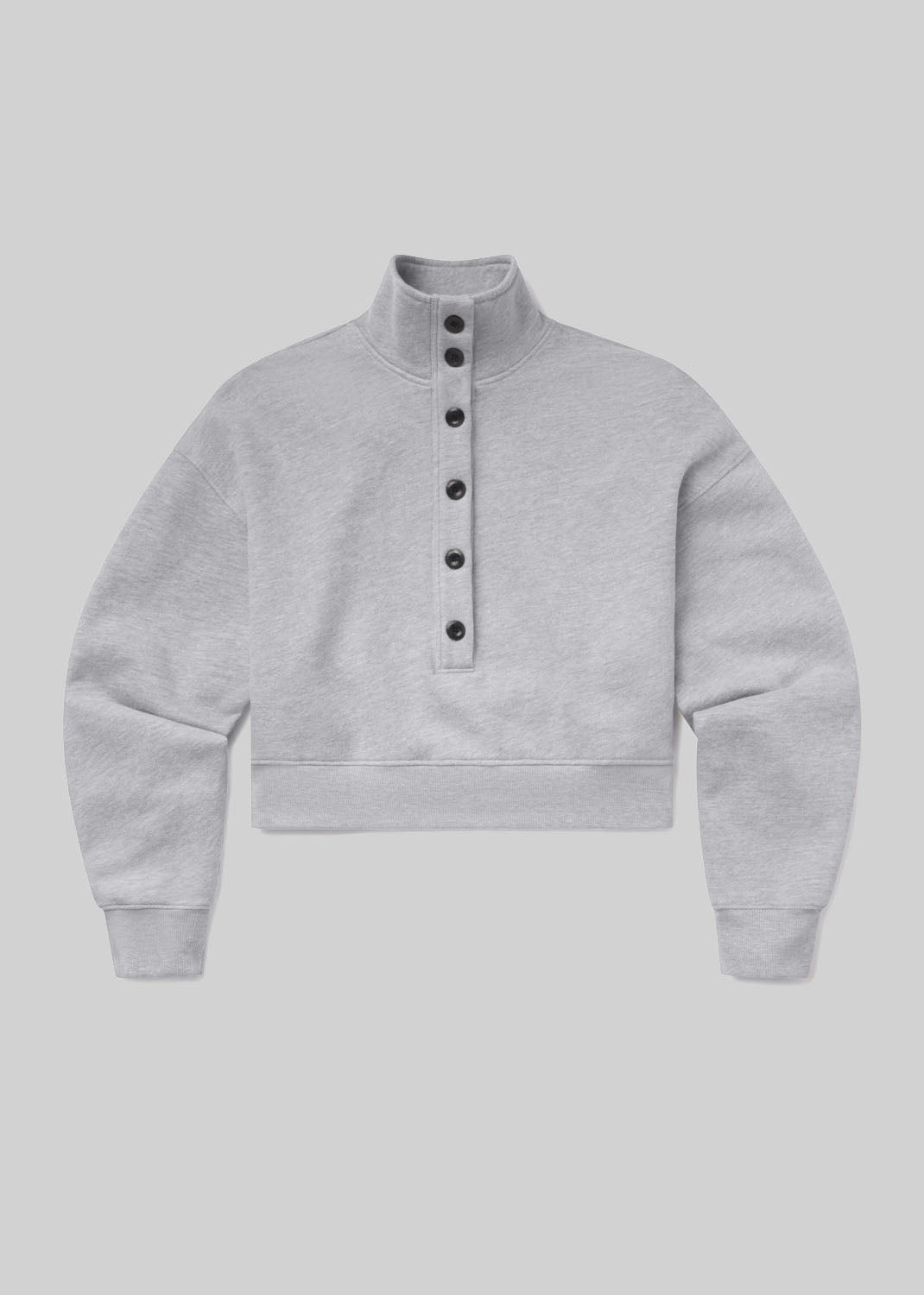 Heather grey cropped sweatshirt with a funnel neckline, front button placket, dropped shoulders, long sleeves, ribbed cuffs, and a banded hem, front flat lay view on a grey background.