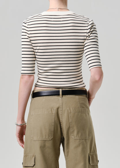 Person wearing a striped shirt and cargo pants on a plain background