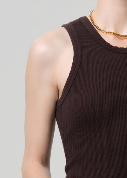 Brown tank top worn by a person on a gray background