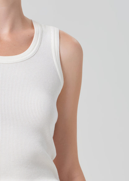 White sleeveless top worn by a person on a light gray background
