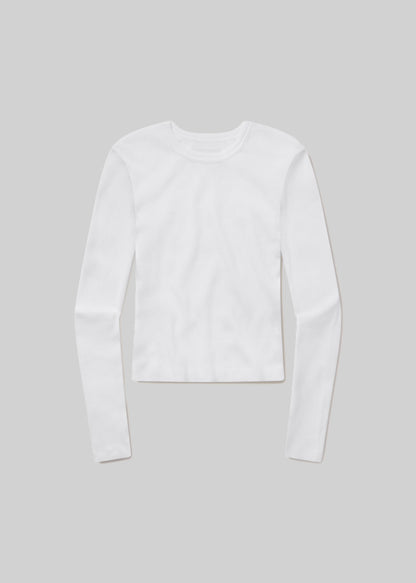 White long-sleeve ribbed crewneck top with a fitted silhouette and straight hem, front flat lay view on a grey background.