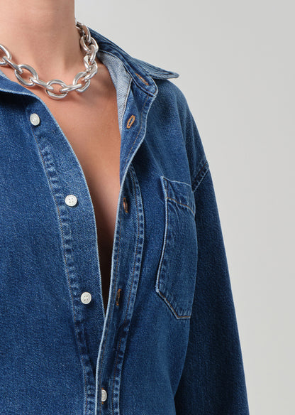close up of a blue denim shirt worn by a person