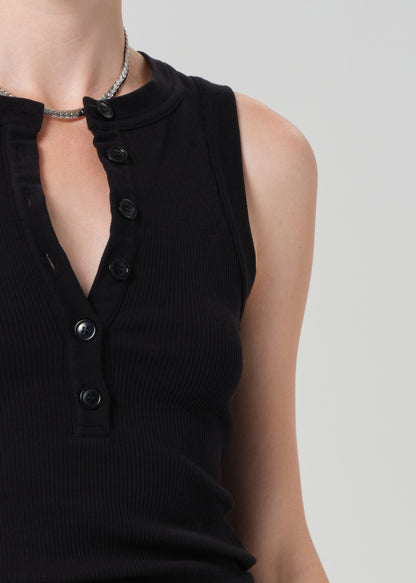Black sleeveless top with buttons on a plain background