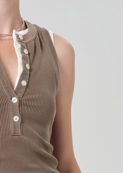 Brown ribbed tank top with white buttons on a neutral background