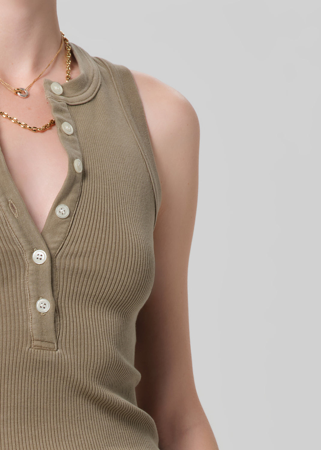 Brown ribbed tank top with buttons on a plain background