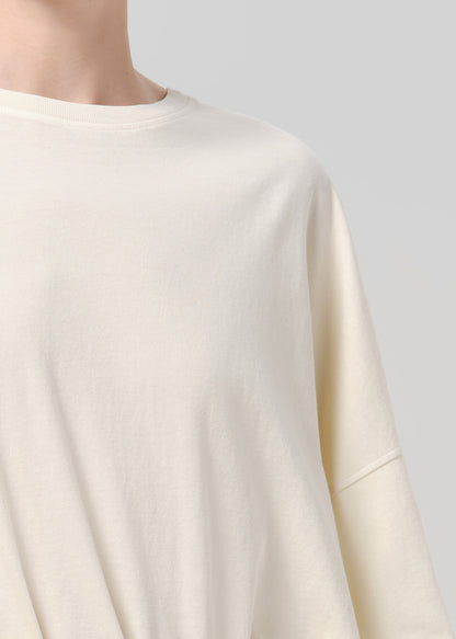 Close up of off white tee on a grey backround