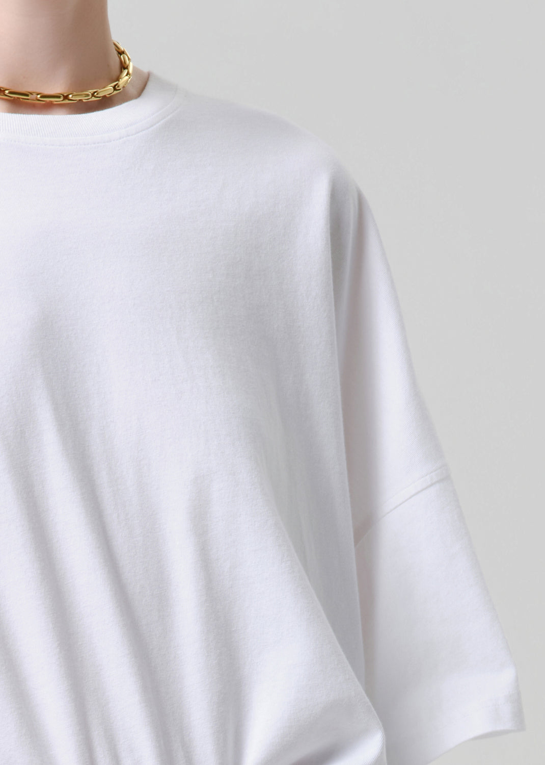 White t-shirt on a mannequin with a grey background