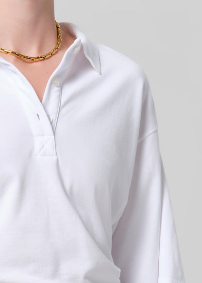 White shirt worn by a person on a plain background