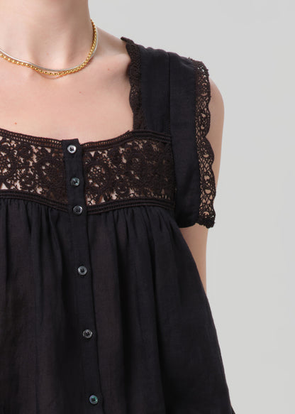 Black dress with lace details on a grey background