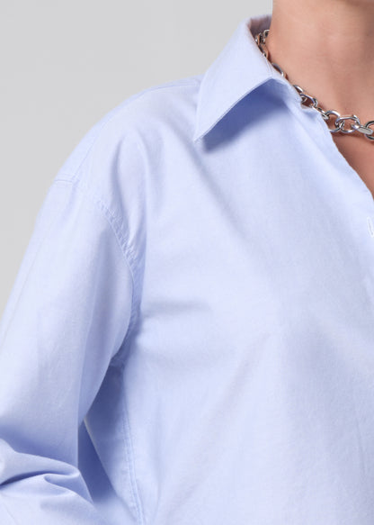 Light blue shirt worn by a person with a neutral background