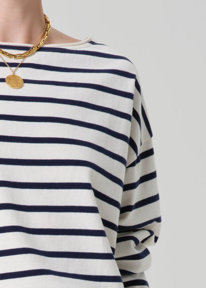 Navy and white striped shirt worn by a person on a light gray background