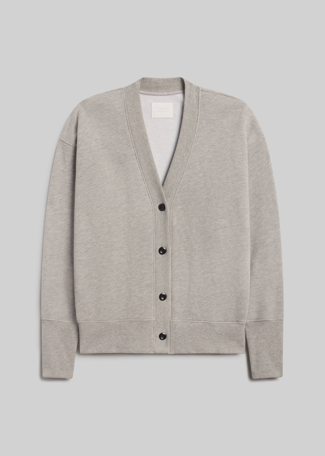 Fleece cardigan in heather grey, featuring a relaxed silhouette, deep V-neckline, four-button front closure, dropped shoulders, long sleeves, and ribbed cuffs and hem, front view on a grey background.