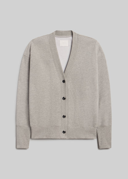 Fleece cardigan in heather grey, featuring a relaxed silhouette, deep V-neckline, four-button front closure, dropped shoulders, long sleeves, and ribbed cuffs and hem, front view on a grey background.