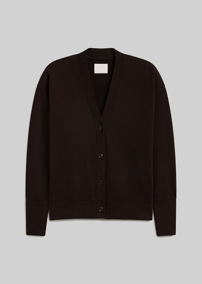 Dark chocolate brown fleece cardigan featuring a relaxed silhouette, deep V-neckline, four-button front closure, dropped shoulders, long sleeves, and ribbed cuffs and hem, front view on a grey background.