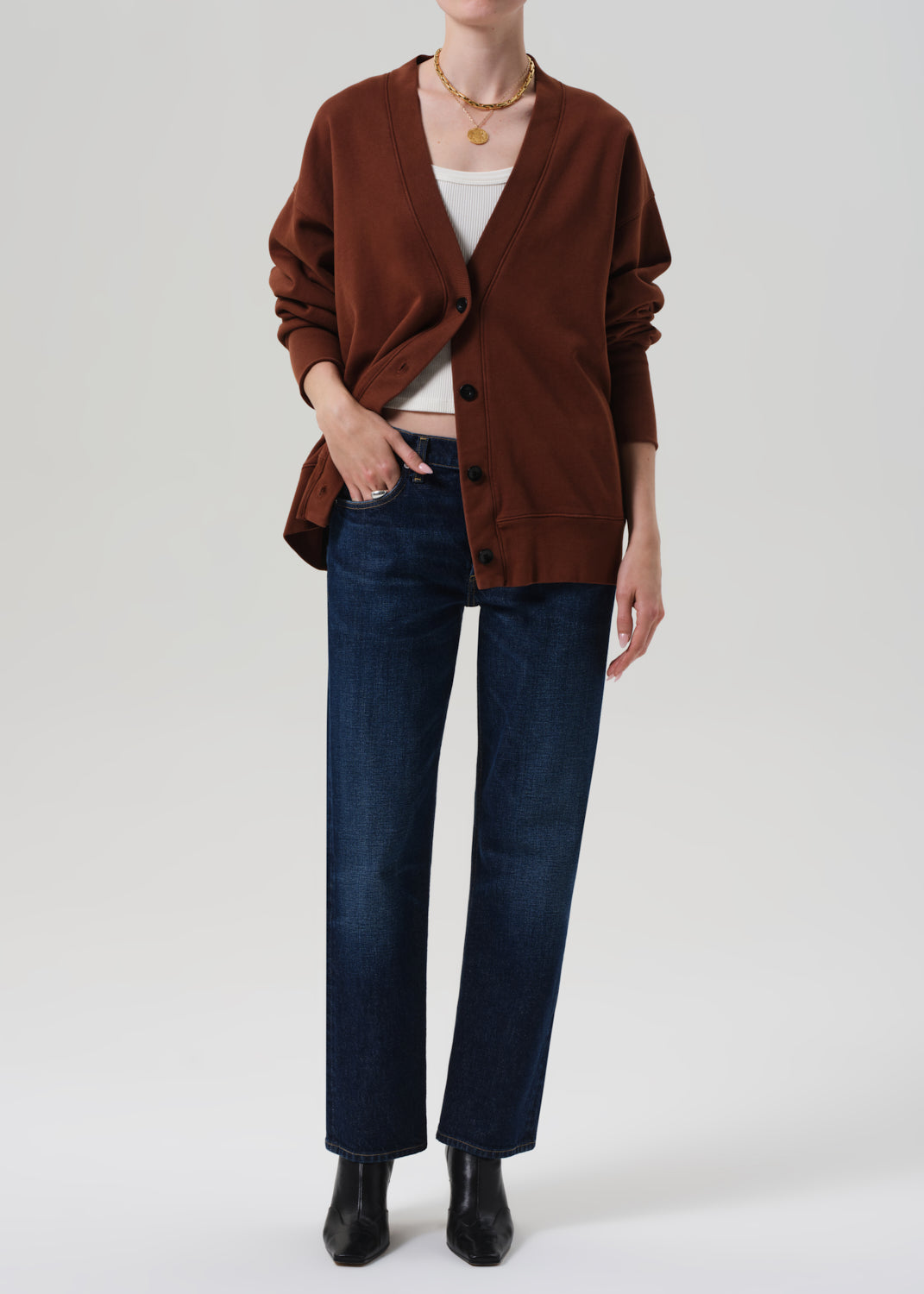 Brown cardigan worn by a person on a plain background