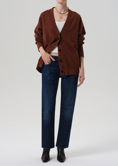 Brown cardigan worn by a person on a plain background