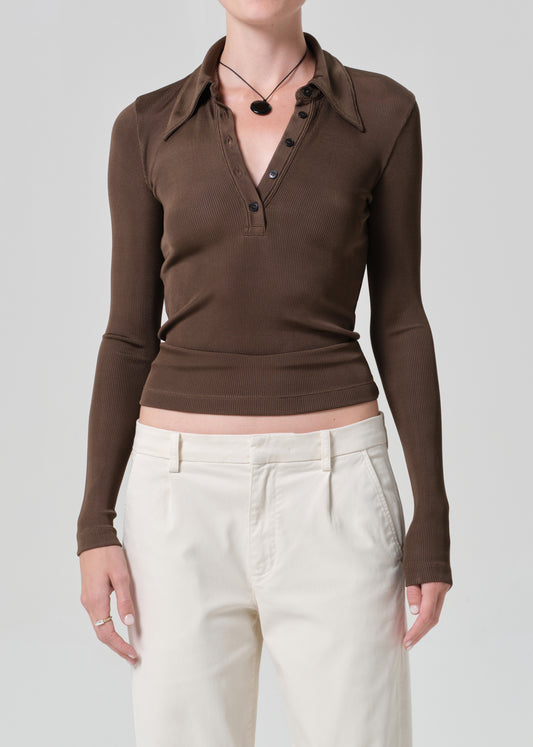 Brown long-sleeve shirt worn by a person on a plain background