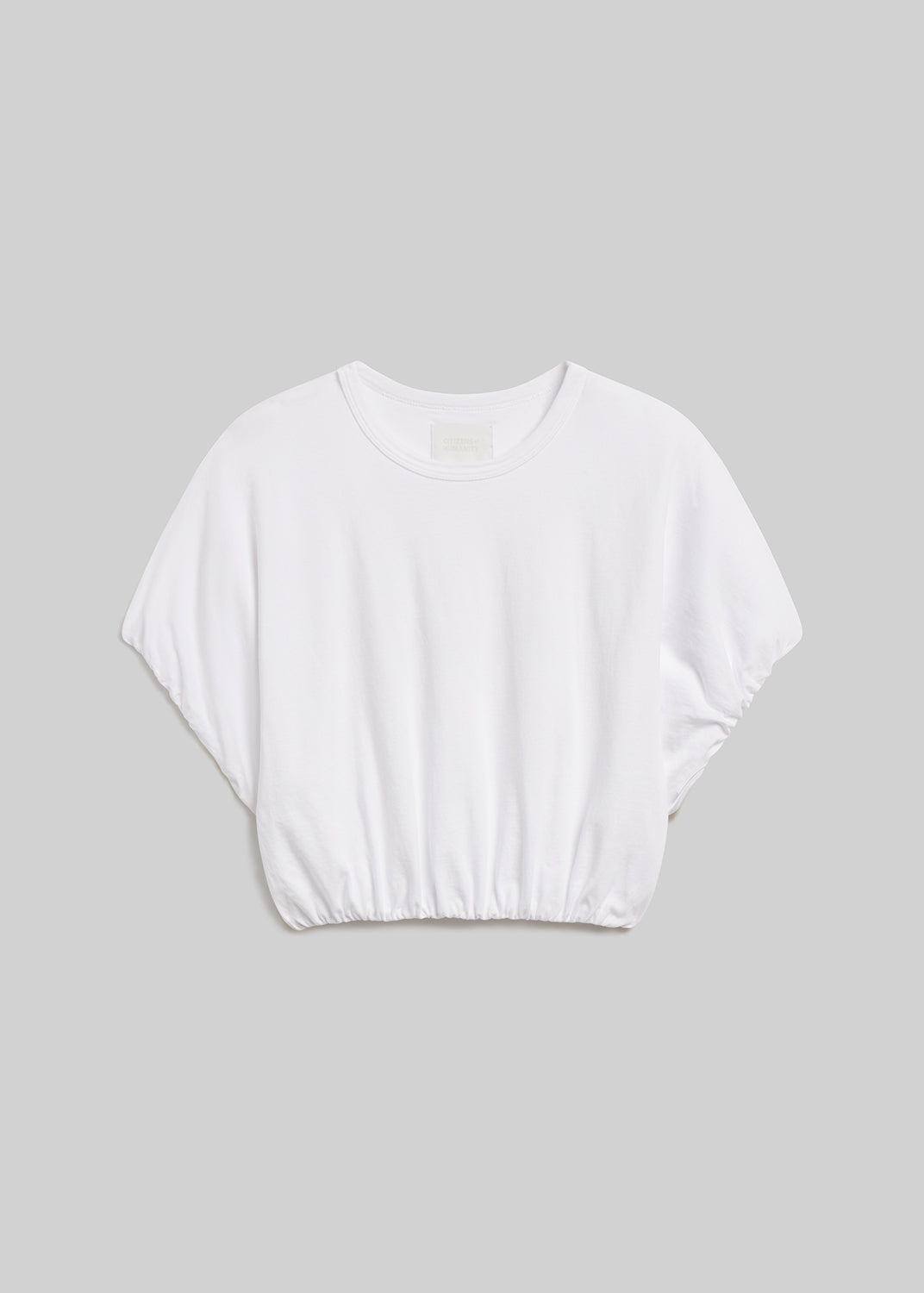 Soft white short-sleeve bubble tee on grey background