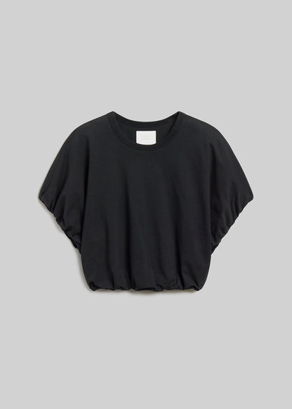 Washed black short-sleeve bubble tee on grey background