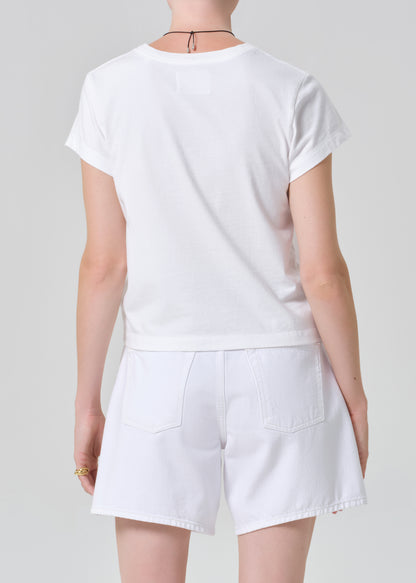 Person wearing a white t-shirt and shorts on a plain background