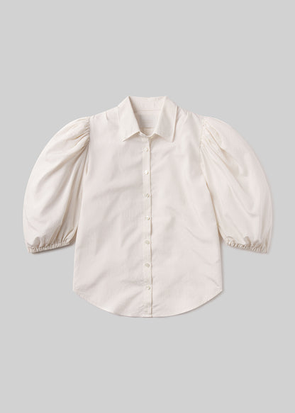 White blouse with puff sleeves on a gray background