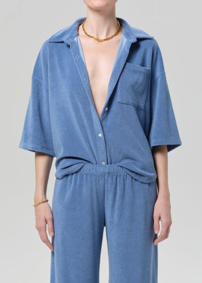 Blue terry set worn by a person on a plain background