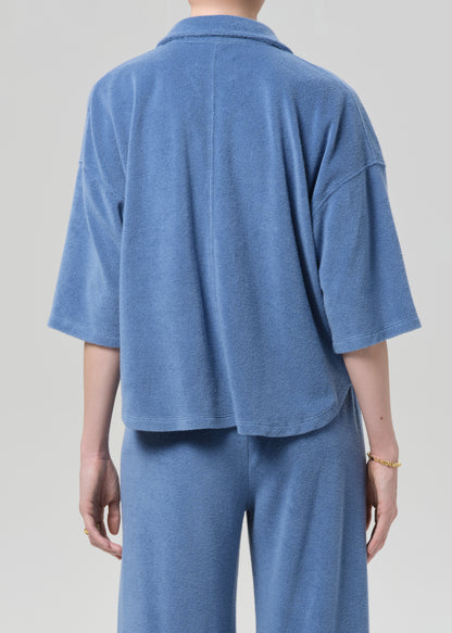 Blue terry set worn by a person on a plain background