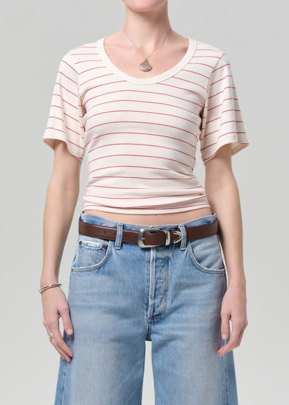 Person wearing a striped shirt and jeans on a plain background
