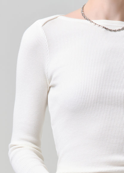 White ribbed sweater on a grey background