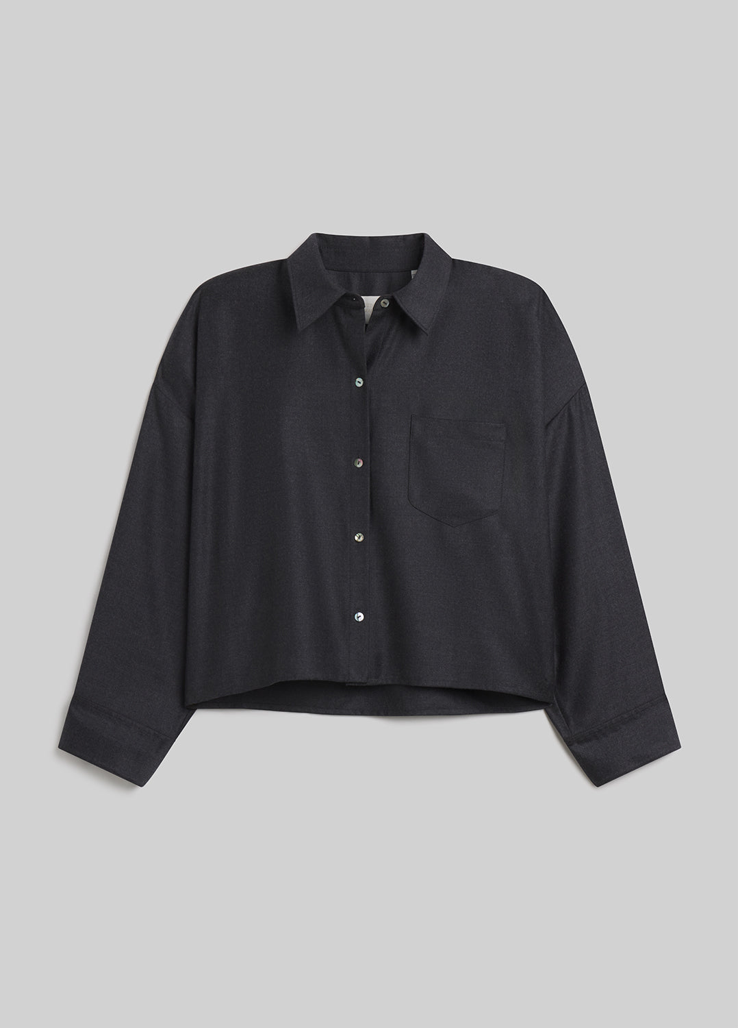 Person wearing heather grey button-down shirt on grey background