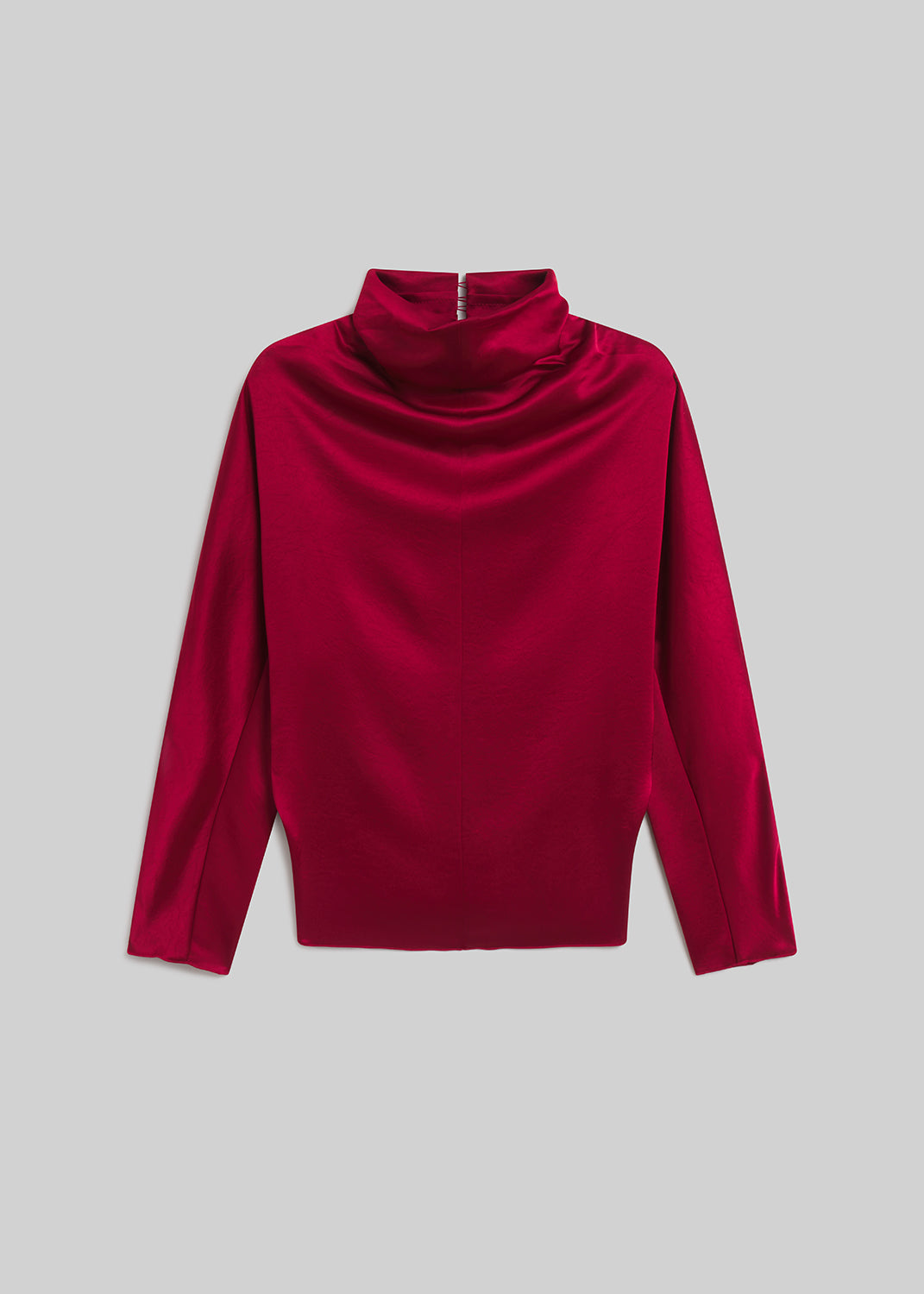 Red satin draped mock-neck top on grey background