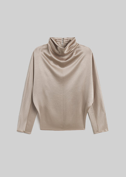 Champagne satin draped mock-neck top on grey background