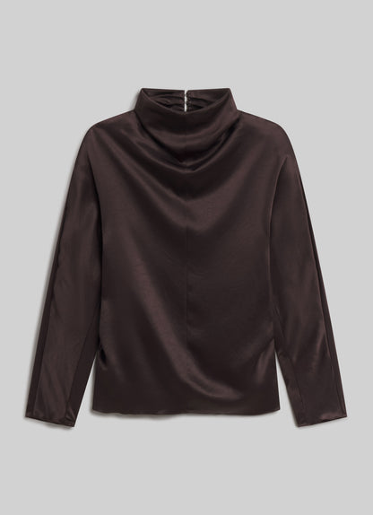 Dark espresso brown long sleeve satin top with a draped high neckline, subtle sheen, and relaxed silhouette, front flat view on a grey background.