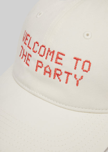 Cream cap with 'Welcome to the Party' text in red on a white background