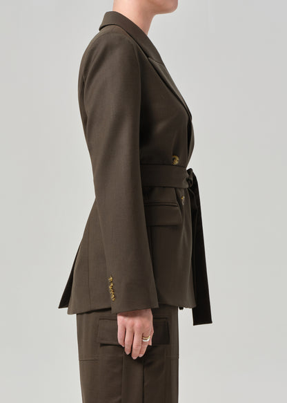 Brown suit jacket and pants on a plain background