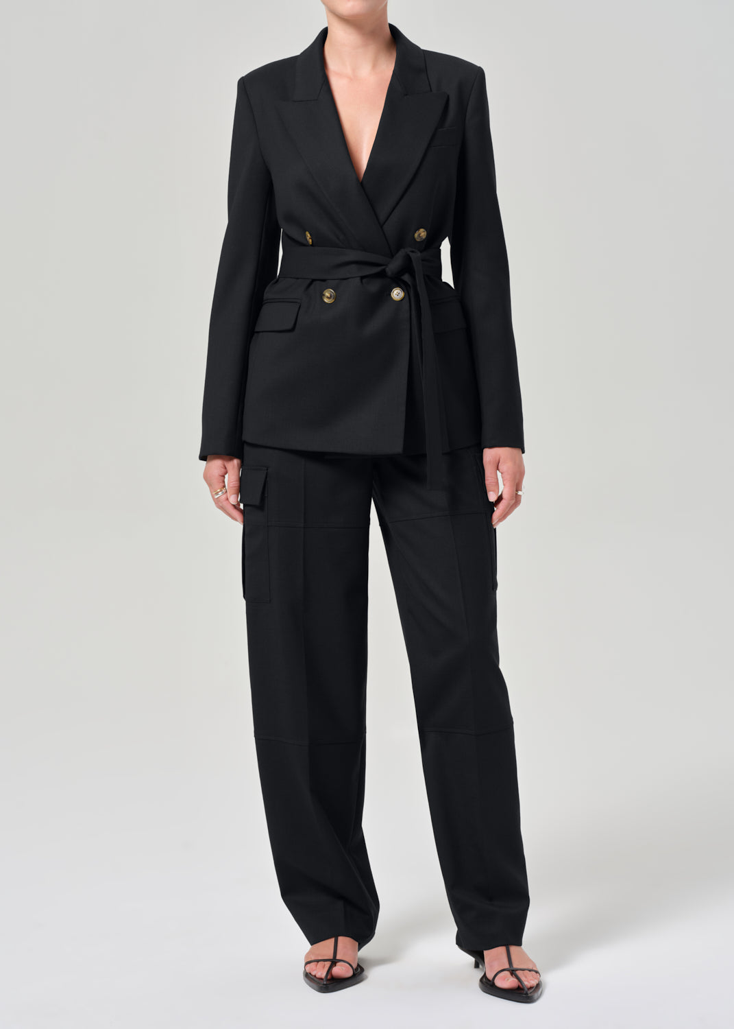 Black suit with gold buttons on a grey background