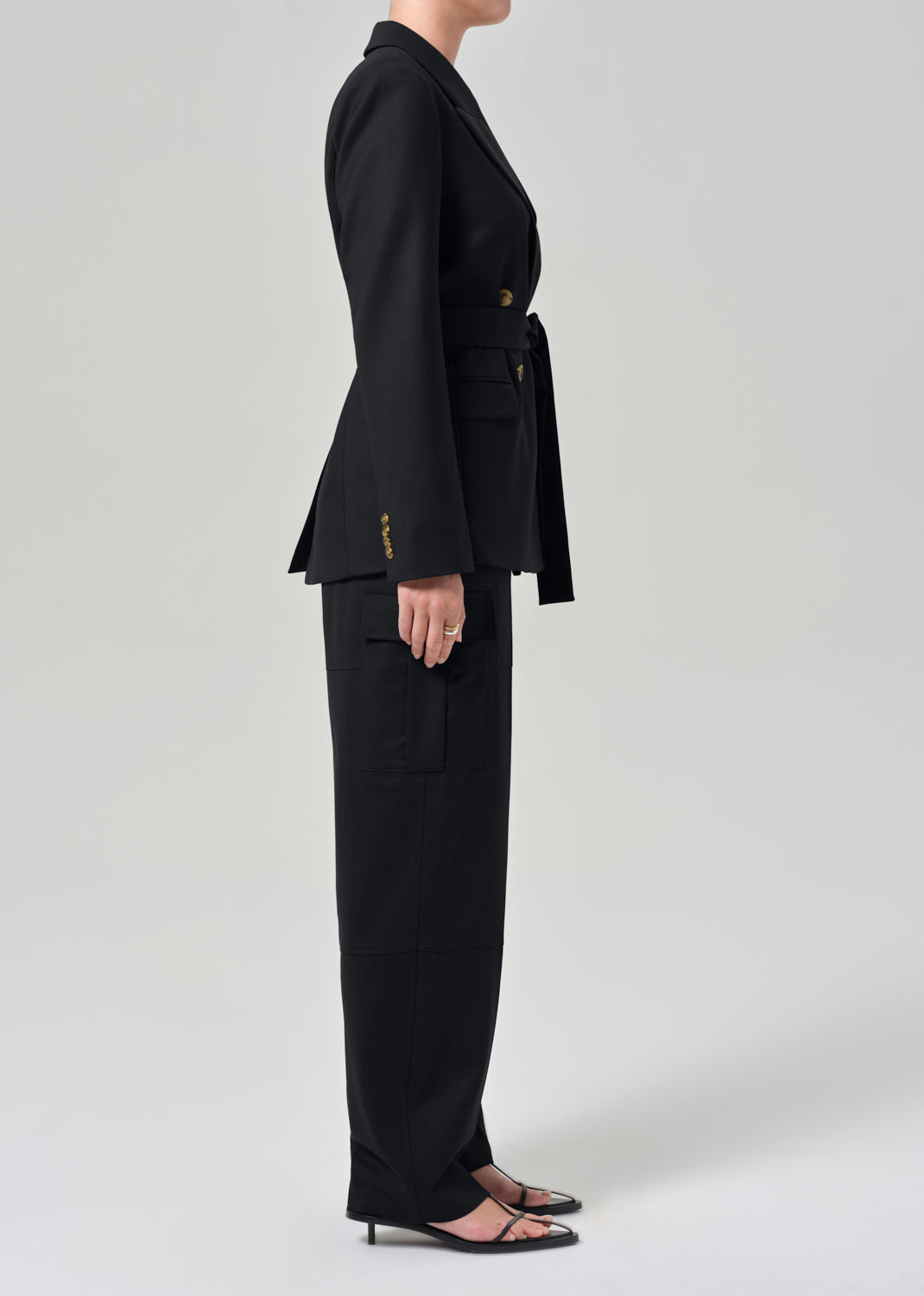 Black suit with gold buttons on a grey background