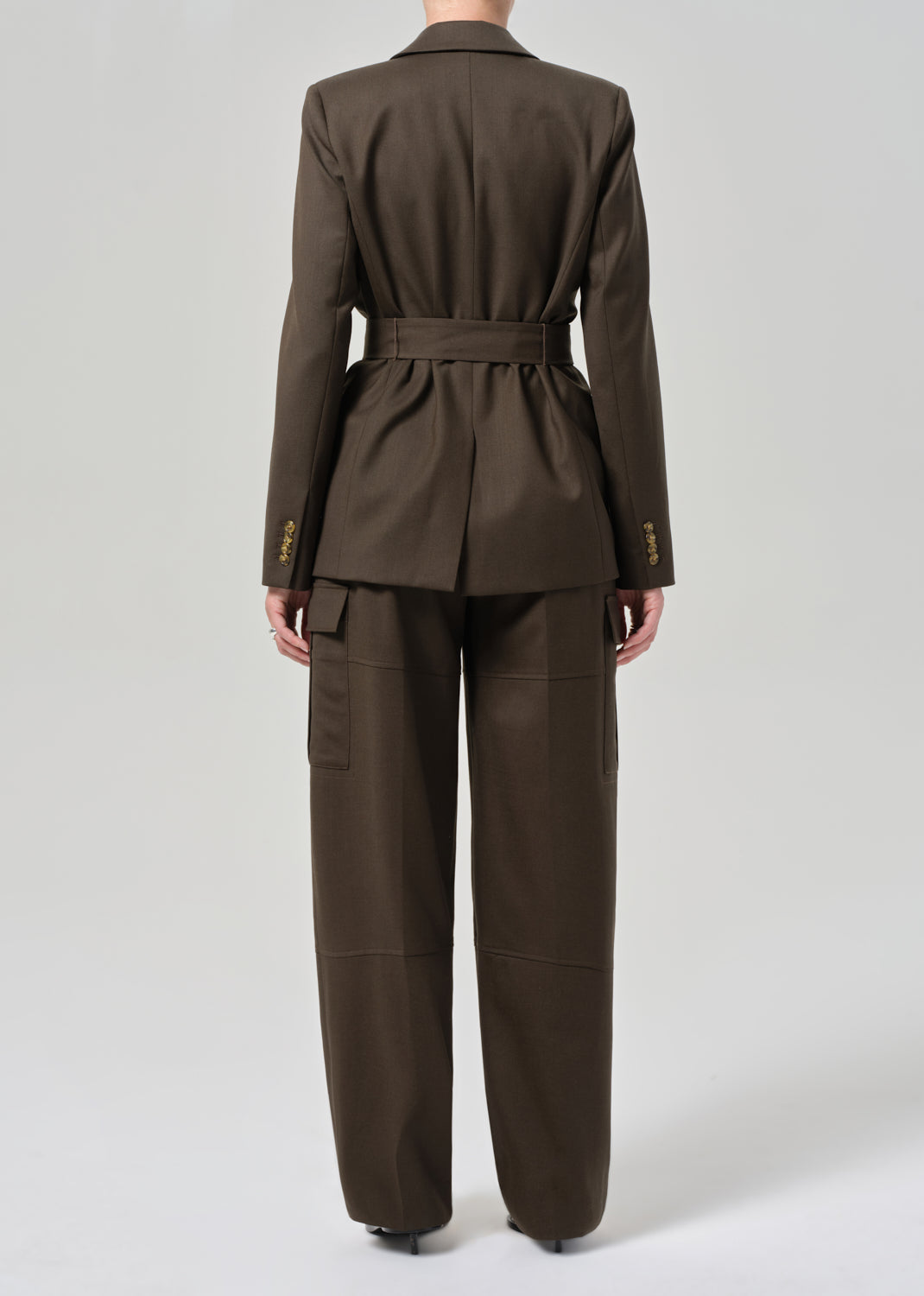Brown suit with a belt on a grey background