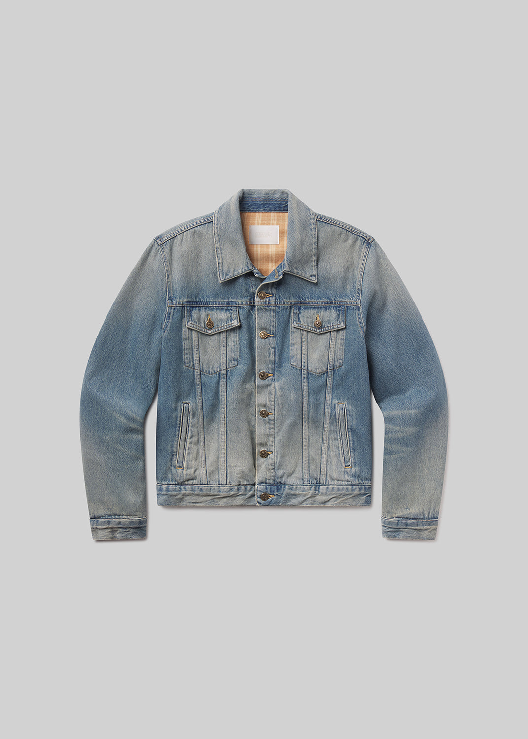 Flat shot of blue denim jacket on a grey background