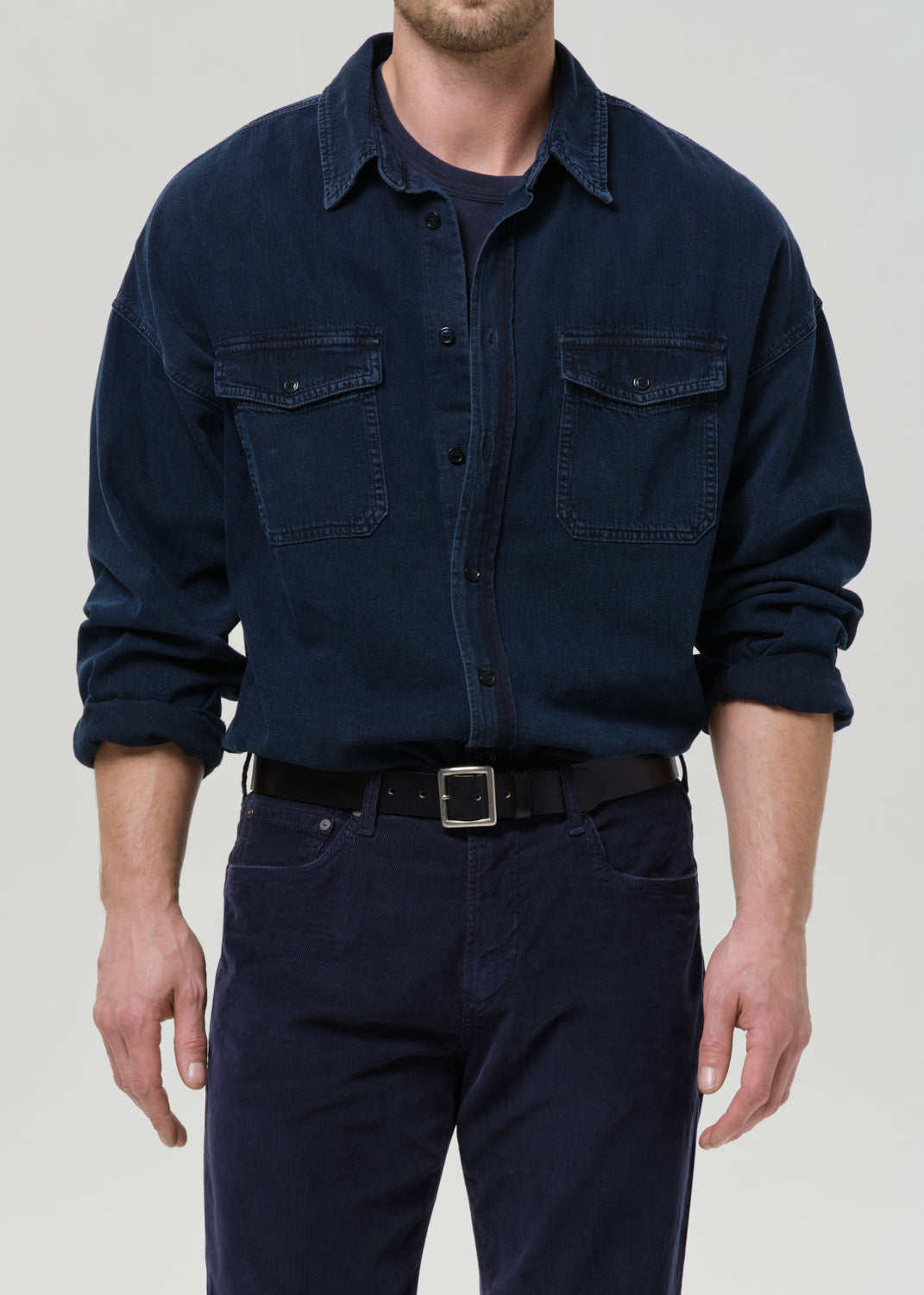 Dark navy button-up shirt on a grey background.